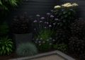 Modern garden featuring dark-colored foliage and decor enhancing outdoor space aesthetics